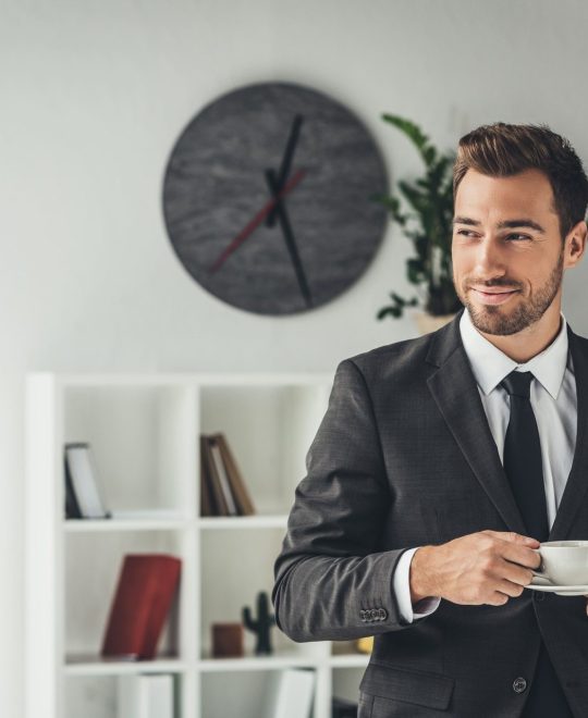 happy-young-businessman-with-cup-of-coffee-at-offi-JB7JNZ8.jpg happy-young-businessman-with-cup-of-coffee-at-offi-JB7JNZ8.jpg